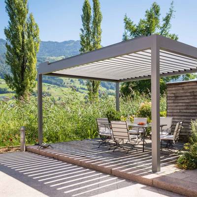 Dining table with chairs in the shade of STOBAG Pavilion